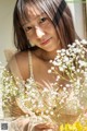 A woman holding a bunch of flowers in her hands.